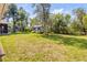 A verdant backyard features a storage shed surrounded by lush greenery at 200 W Washington Ave, Deland, FL 32720