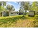 A spacious backyard featuring outbuildings and lush green grass at 200 W Washington Ave, Deland, FL 32720