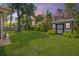 Well-maintained backyard with a storage shed, green lawn, and privacy fence, perfect for outdoor activities at 200 W Washington Ave, Deland, FL 32720