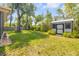 Spacious backyard featuring a storage shed with mature trees and partial fencing at 200 W Washington Ave, Deland, FL 32720