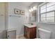 Bathroom with a marble-top vanity, framed mirror, and modern lighting at 200 W Washington Ave, Deland, FL 32720