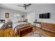 Cozy bedroom featuring hardwood floors, a ceiling fan, and natural light at 200 W Washington Ave, Deland, FL 32720