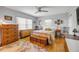 Bright bedroom featuring hardwood floors, a ceiling fan, and neutral-toned walls at 200 W Washington Ave, Deland, FL 32720