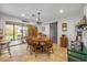 Dining area with an octagonal wood table, chandelier, and sliding barn door at 200 W Washington Ave, Deland, FL 32720