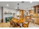 Open-concept dining area with an octagonal wood table, chandelier, and access to the kitchen at 200 W Washington Ave, Deland, FL 32720