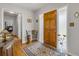 Welcoming foyer with a wooden door, decorative rug, and hardwood flooring leading to other areas of the house at 200 W Washington Ave, Deland, FL 32720