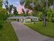 Aerial view of a well-maintained home with an extended driveway and a lush green lawn at 200 W Washington Ave, Deland, FL 32720