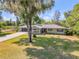 Beautiful home with a well-manicured lawn and mature trees that create a serene outdoor atmosphere at 200 W Washington Ave, Deland, FL 32720