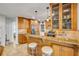 A kitchen featuring wooden cabinets, granite countertops, a breakfast bar, and pendant lighting at 200 W Washington Ave, Deland, FL 32720