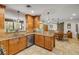 A kitchen with wood cabinets, stainless steel appliances, granite counters, and a breakfast bar overlooking the dining area at 200 W Washington Ave, Deland, FL 32720