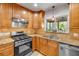 This kitchen features wooden cabinets, granite countertops, and stainless steel appliances at 200 W Washington Ave, Deland, FL 32720