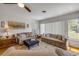 Comfortable living room featuring a ceiling fan, hardwood floors, and comfortable sofas at 200 W Washington Ave, Deland, FL 32720