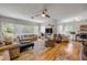Bright living room with large windows, ceiling fan, hardwood floors, and comfortable seating at 200 W Washington Ave, Deland, FL 32720