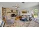 Comfortable living room featuring a decorative fireplace, built-in shelves, and hardwood floors at 200 W Washington Ave, Deland, FL 32720