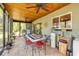 Enclosed tiled patio with ceiling fans, dining table, and views of the backyard at 200 W Washington Ave, Deland, FL 32720