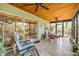 Enclosed sunroom featuring tile floors, patio seating, and lots of light at 200 W Washington Ave, Deland, FL 32720