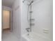 Bright bathroom featuring a shower-tub combo with white tiled walls, chrome fixtures and coat hooks at 210 Delespine Dr, Debary, FL 32713