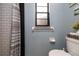 Stylish bathroom with subway tile shower, gray walls, a framed window, and toilet at 210 Delespine Dr, Debary, FL 32713