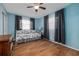 Guest bedroom features wood laminate flooring, aqua colored walls, and an inviting day bed at 210 Delespine Dr, Debary, FL 32713