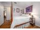 Cozy bedroom with a four-poster bed, hardwood floors, and decorative wall hangings at 210 Delespine Dr, Debary, FL 32713