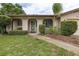 Inviting entryway with arched facade, a welcoming bench, and a walkway leading to the front door at 210 Delespine Dr, Debary, FL 32713