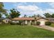 Charming single-story home with a well-manicured lawn, lush landscaping, and inviting curb appeal at 210 Delespine Dr, Debary, FL 32713