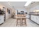 Bright kitchen featuring stainless steel appliances, white cabinets, a kitchen island, and tiled flooring at 210 Delespine Dr, Debary, FL 32713