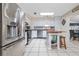 Modern kitchen with stainless steel appliances, center island, white cabinetry, and a skylight at 210 Delespine Dr, Debary, FL 32713