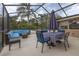 Enclosed lanai featuring outdoor furniture and a view of the lush backyard and pool at 210 Delespine Dr, Debary, FL 32713