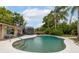 Backyard swimming pool surrounded by mature trees and lush landscaping at 210 Delespine Dr, Debary, FL 32713