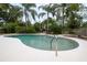 Inviting in-ground pool surrounded by lush greenery and mature palm trees at 210 Delespine Dr, Debary, FL 32713