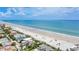 Expansive aerial view showcases a beach neighborhood with beautiful ocean views at 2101 Hill St, New Smyrna Beach, FL 32169