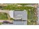 A high-angle aerial shot shows the architectural details of the roof, patio, driveway, and surrounding greenery at 2101 Hill St, New Smyrna Beach, FL 32169