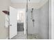 Modern bathroom with glass-enclosed shower, pebble floor, and updated vanity at 2101 Hill St, New Smyrna Beach, FL 32169