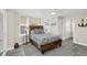 Inviting bedroom with stylish wood-look bed, bright windows, and neutral decor at 2101 Hill St, New Smyrna Beach, FL 32169