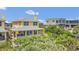 Beautiful two-story home with a charming porch and lush landscaping, offering a perfect blend of comfort and elegance at 2101 Hill St, New Smyrna Beach, FL 32169