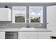 Bright kitchen features white cabinetry, sink, and view of outside at 2101 Hill St, New Smyrna Beach, FL 32169