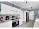 Well-lit kitchen features stainless steel appliances and white cabinets at 2101 Hill St, New Smyrna Beach, FL 32169
