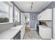 Bright kitchen with stainless steel appliances, white cabinets, and wood look floors at 2101 Hill St, New Smyrna Beach, FL 32169
