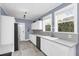 Charming kitchen boasts ample counter space and serene outdoor views at 2101 Hill St, New Smyrna Beach, FL 32169