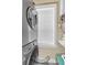 Laundry area featuring a modern washer and dryer set, bright window, and ample lighting at 2101 Hill St, New Smyrna Beach, FL 32169