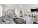 Comfortable living room featuring sofa, coffee table, and bright windows at 2101 Hill St, New Smyrna Beach, FL 32169