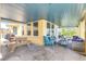 A beautiful patio with a blue-painted ceiling and outdoor seating provides a relaxed atmosphere, perfect for entertaining at 2101 Hill St, New Smyrna Beach, FL 32169