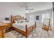 Bedroom with a wooden bed, woven rug, and natural light creates a relaxing space at 2122 S Atlantic Ave # 2122, New Smyrna Beach, FL 32169