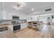 Charming kitchen features white cabinets, stainless steel appliances, granite countertops, and breakfast bar at 2122 S Atlantic Ave # 2122, New Smyrna Beach, FL 32169