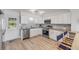 Modern kitchen featuring stainless steel appliances, granite countertops, and white cabinetry at 2122 S Atlantic Ave # 2122, New Smyrna Beach, FL 32169