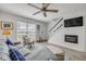 Inviting living room with a comfy gray sofa, a window with blinds, and a decorative chair at 2122 S Atlantic Ave # 2122, New Smyrna Beach, FL 32169