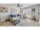 Cozy living room with a gray sofa, guitars on the wall, and a window with natural light at 2122 S Atlantic Ave # 2122, New Smyrna Beach, FL 32169