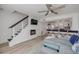 Stylish living room featuring a fireplace, TV, a stairway and access to the kitchen at 2122 S Atlantic Ave # 2122, New Smyrna Beach, FL 32169