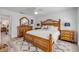 Bright and cozy main bedroom with wood furniture, stylish rug, and a ceiling fan for added comfort at 2122 S Atlantic Ave # 2122, New Smyrna Beach, FL 32169